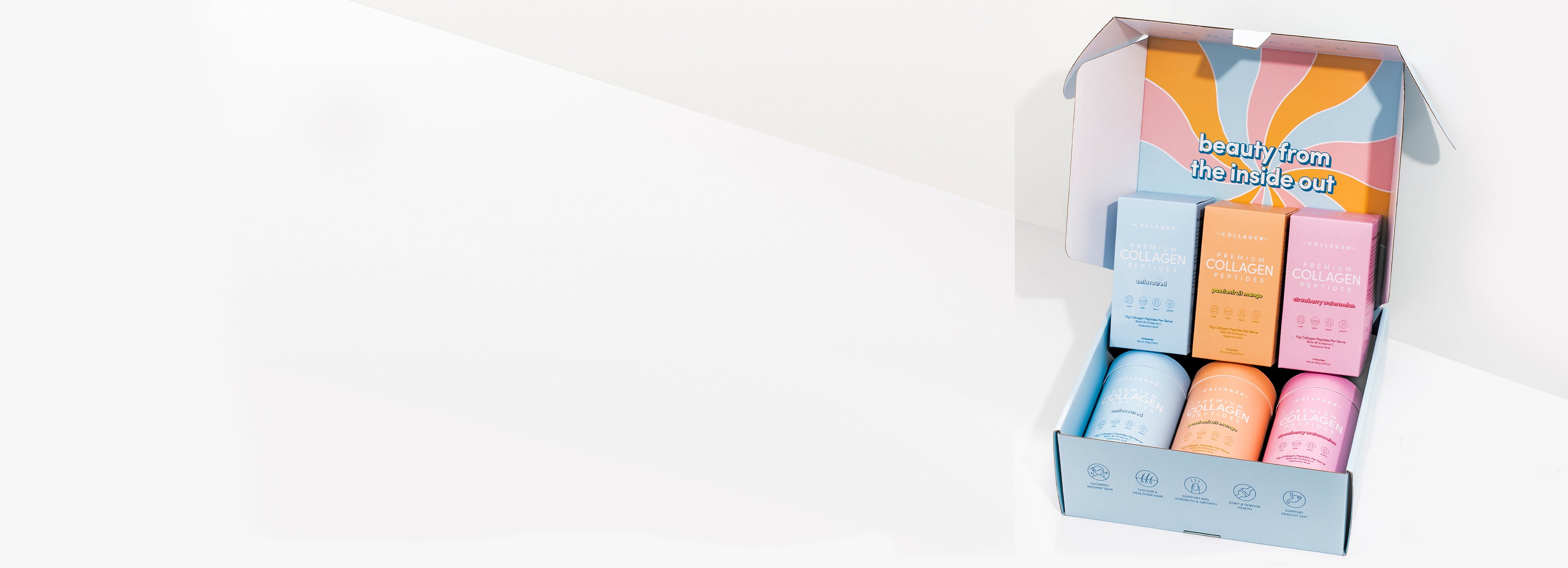 Open box with colorful collagen supplement containers labeled for beauty enhancement. Background is clean and minimalistic.