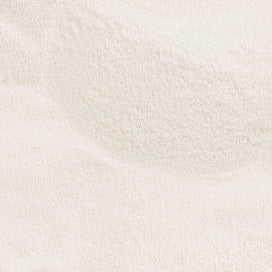Close-up of fine white collagen powder texture, highlighting beauty and skincare supplement properties.