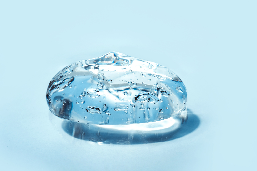 Clear collagen gel blob on a light blue background, highlighting its purity and hydrating properties. Ideal for skincare and beauty supplements.