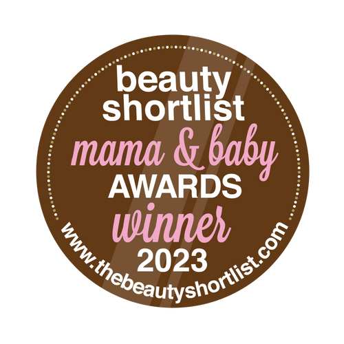 Brown circular badge with white and pink text: "Beauty Shortlist Mama & Baby Awards Winner 2023" and a website link at the bottom.