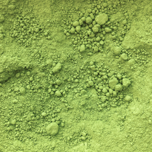 Close-up of vibrant green matcha powder texture, showcasing fine and clumpy granules. Ideal for beauty supplements and collagen-related products.