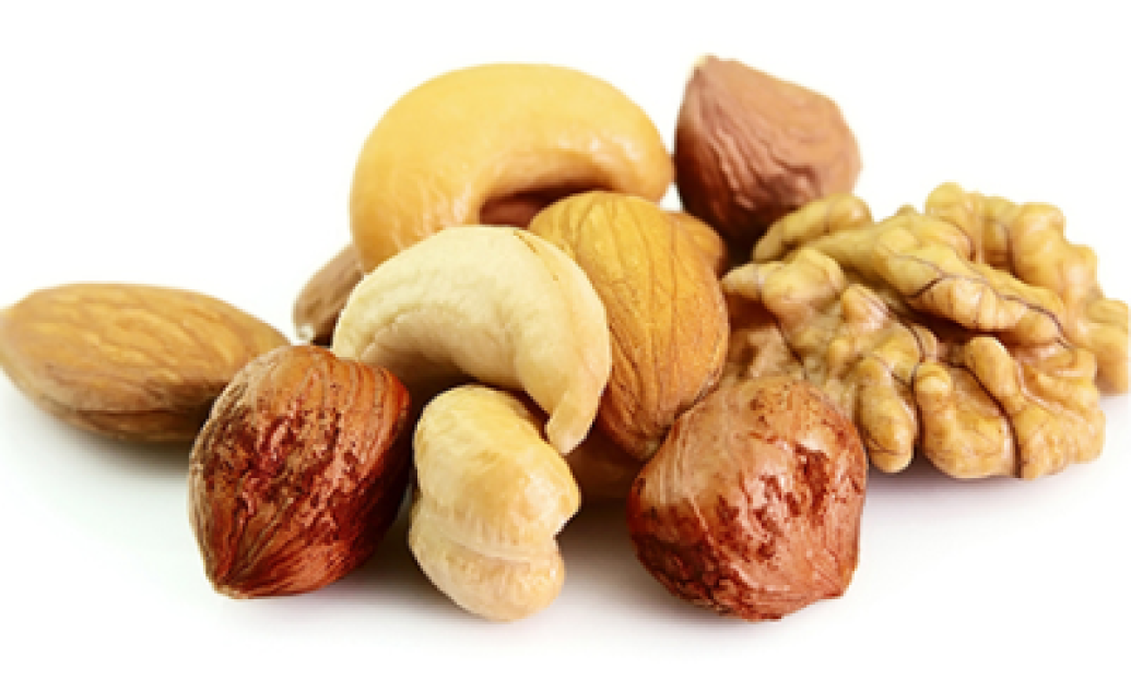 Assorted nuts including cashews, walnuts, and hazelnuts on a white background. Perfect for healthy snacking and beauty nutrients.