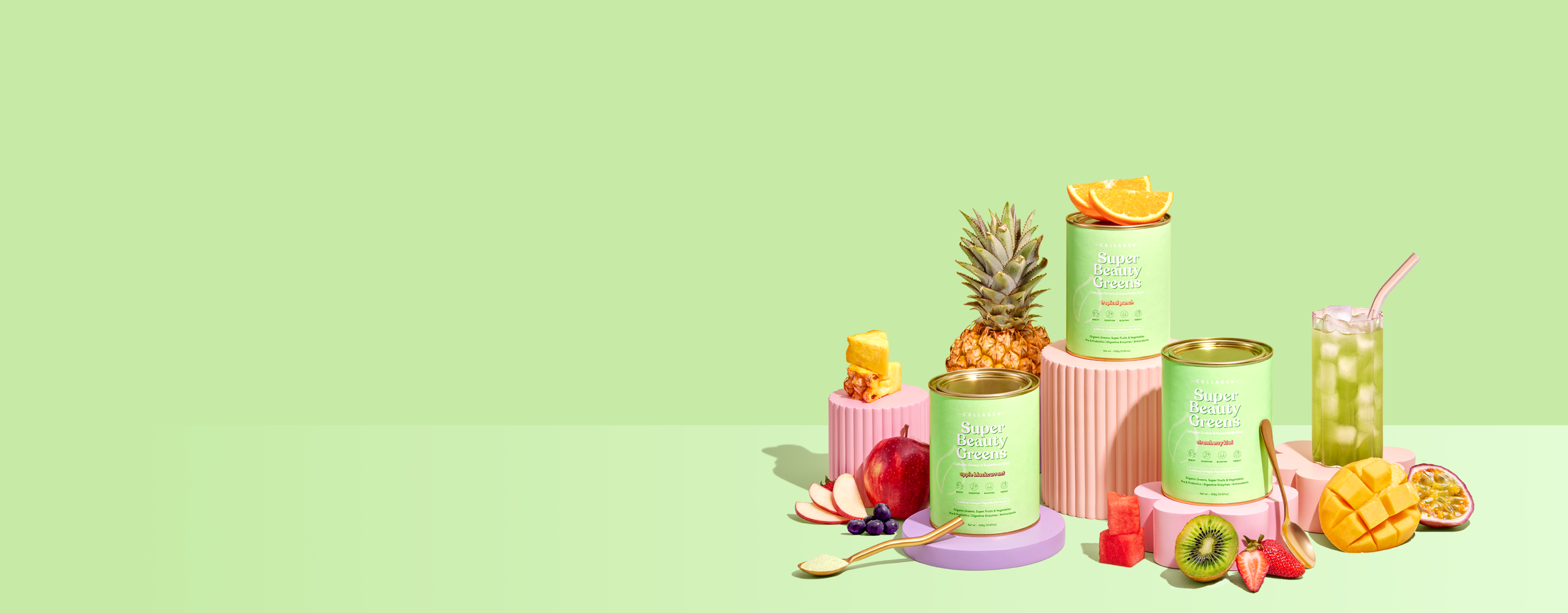Collagen supplement containers with tropical fruits like pineapple, mango, and kiwi, arranged on pink pedestals against a green background.