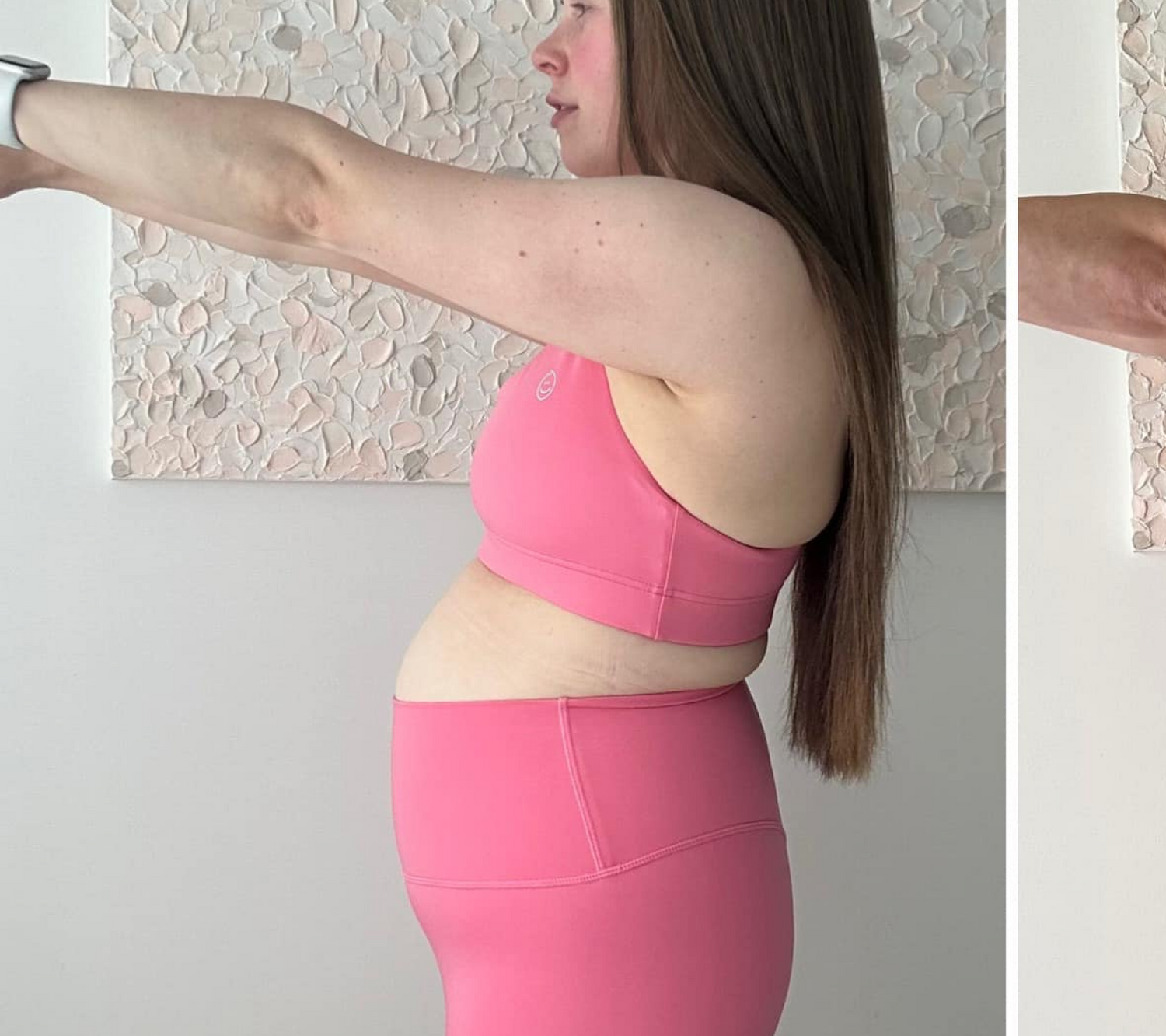 Woman in pink activewear doing a side stretch. Light-toned wall art in the background. Focus on fitness and wellness.