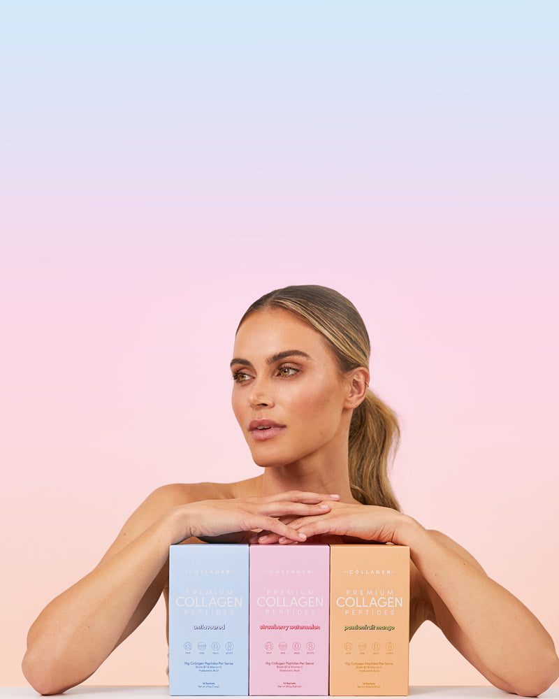 Woman with sleek ponytail rests her arms on three collagen supplement boxes in pastel blue, pink, and orange under a soft gradient background.