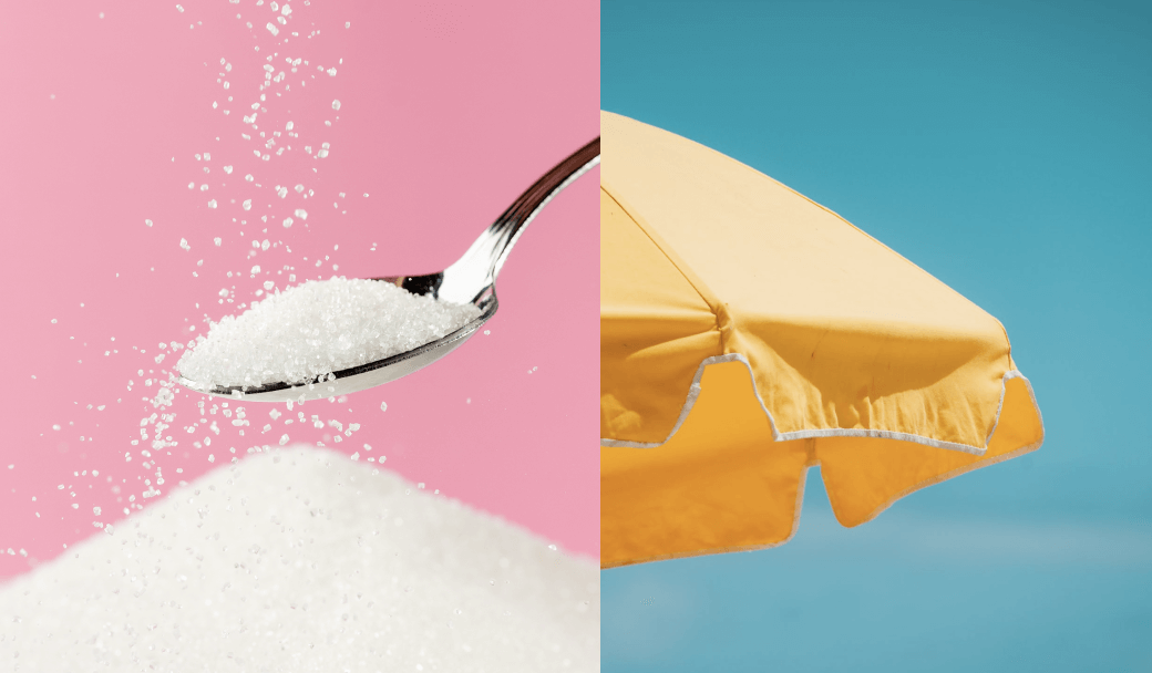 A spoon of white powder against a pink backdrop, beside a yellow beach umbrella under a clear blue sky.
