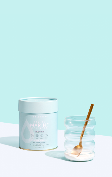 Marine collagen container beside a clear wavy glass with a gold spoon on a blue background. Beauty supplement concept.