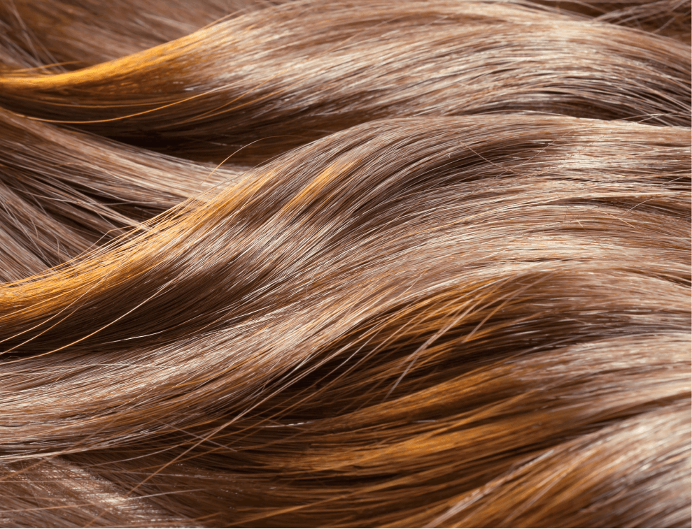 Close-up of shiny, healthy, flowing brown hair, highlighting smooth texture, suggesting the benefits of collagen for hair beauty and wellness.