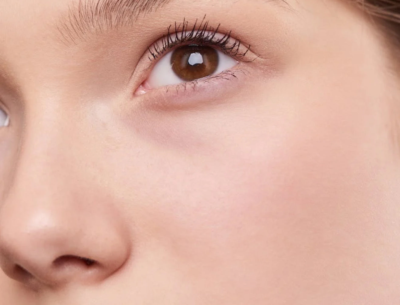 Close-up of a person's eye and smooth skin. Focus on natural beauty, youthful complexion, potential collagen supplement benefits.