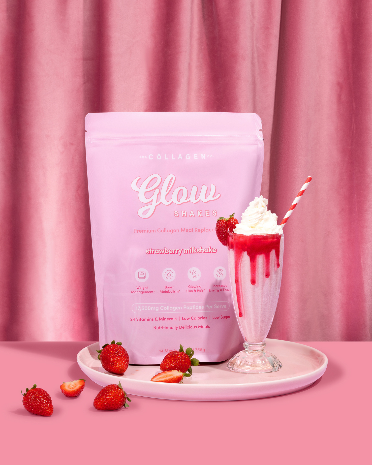 Pink collagen shake bag with a strawberry milkshake in a glass, whipped cream, and fresh strawberries on a pink backdrop for beauty nutrition.