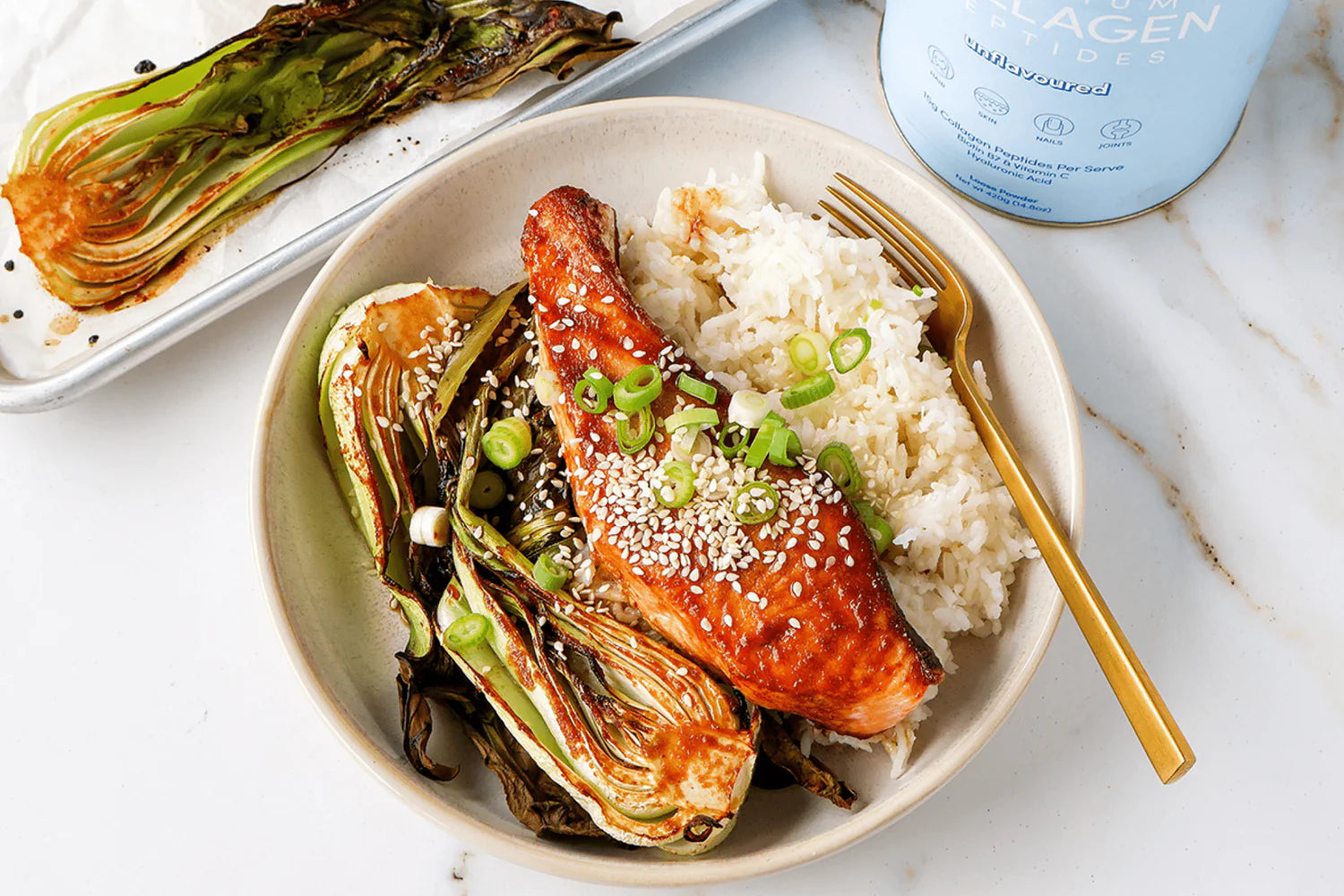 Grilled salmon with sesame seeds, rice, and bok choy on a plate. Collagen container in the background. Ideal for beauty and health supplements.