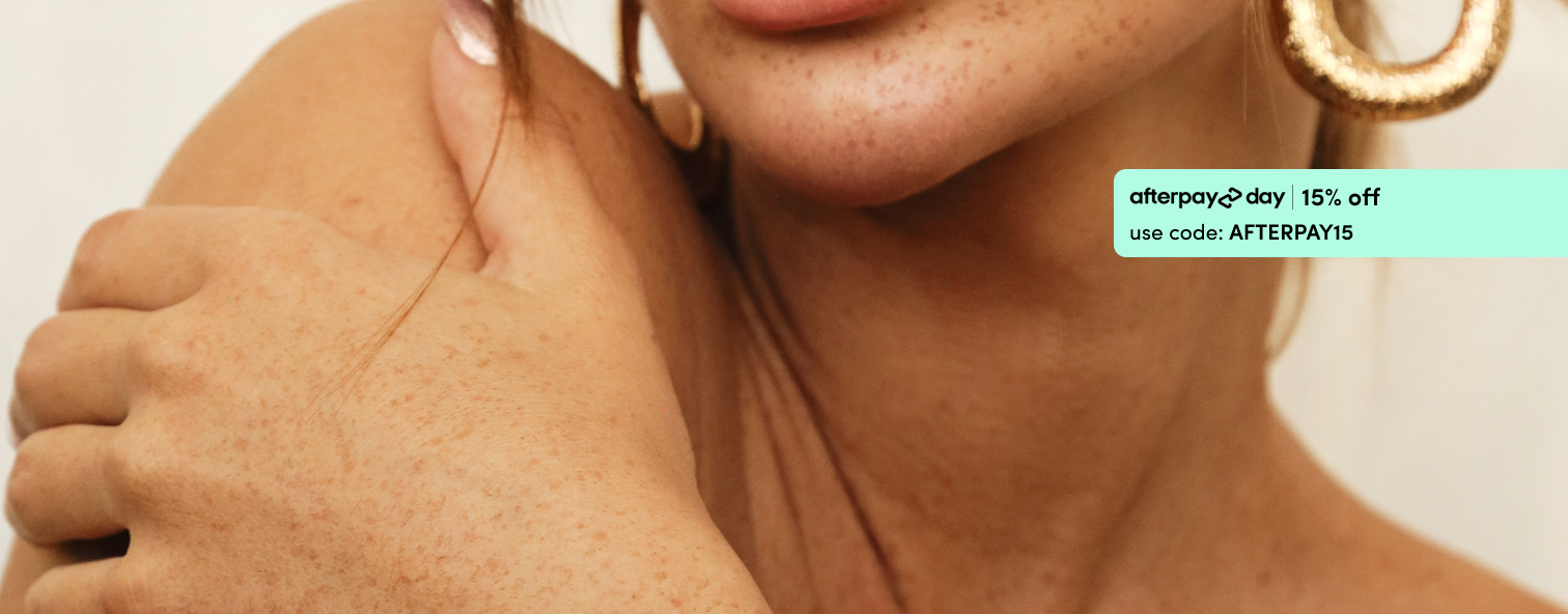 Close-up of a woman's shoulder and face, highlighting freckles and gold hoop earring. Text overlay: "Afterpay 2-day 15% off with code AFTERPAY15".