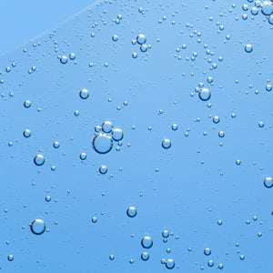 Clear blue liquid with bubbles, resembling a beauty collagen serum or supplement texture. Smooth, hydrating, and refreshing appearance.